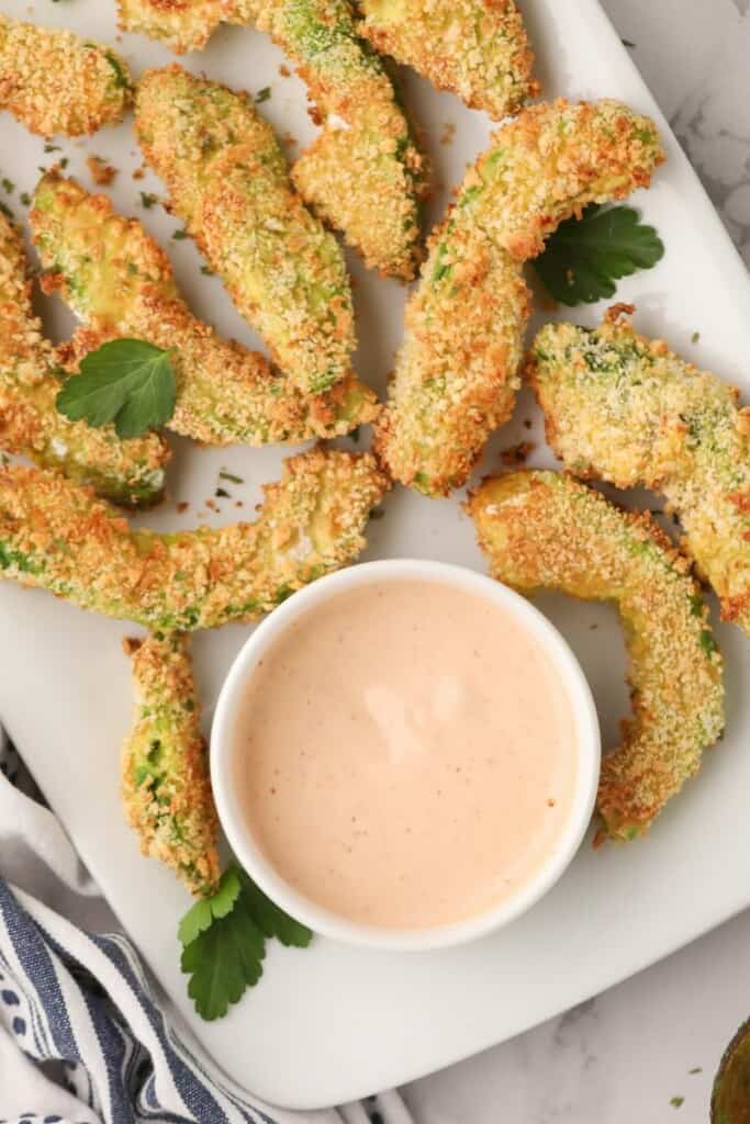 Air Fried Avocado Fries on a white plate with sauce