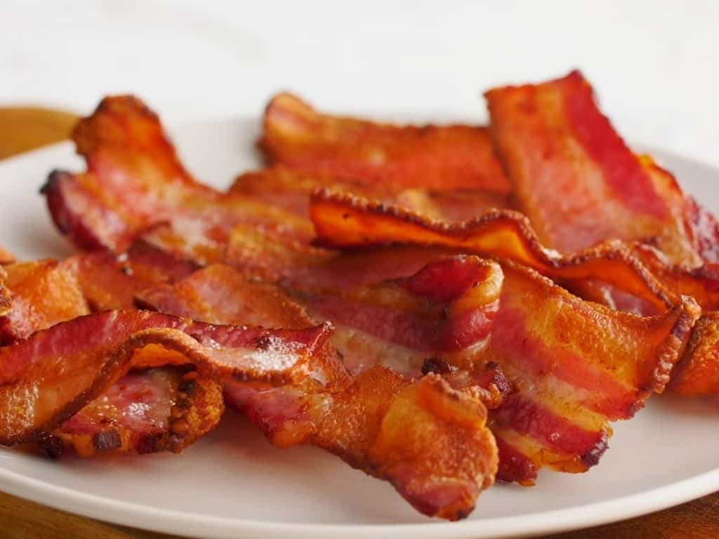Air Fryer Bacon cooked on a white plate