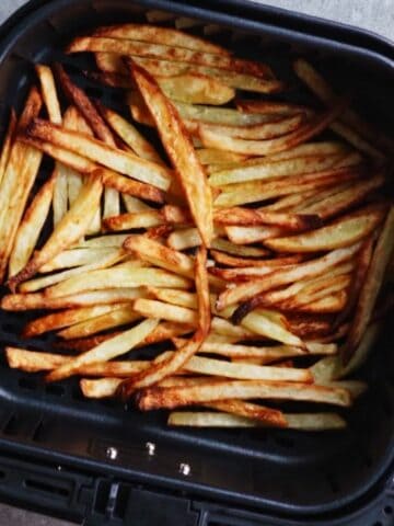 Cooked french fries in air fryer basket
