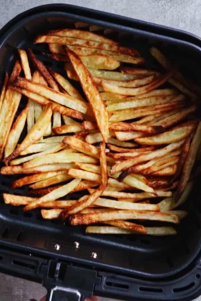 Cooked french fries in air fryer basket