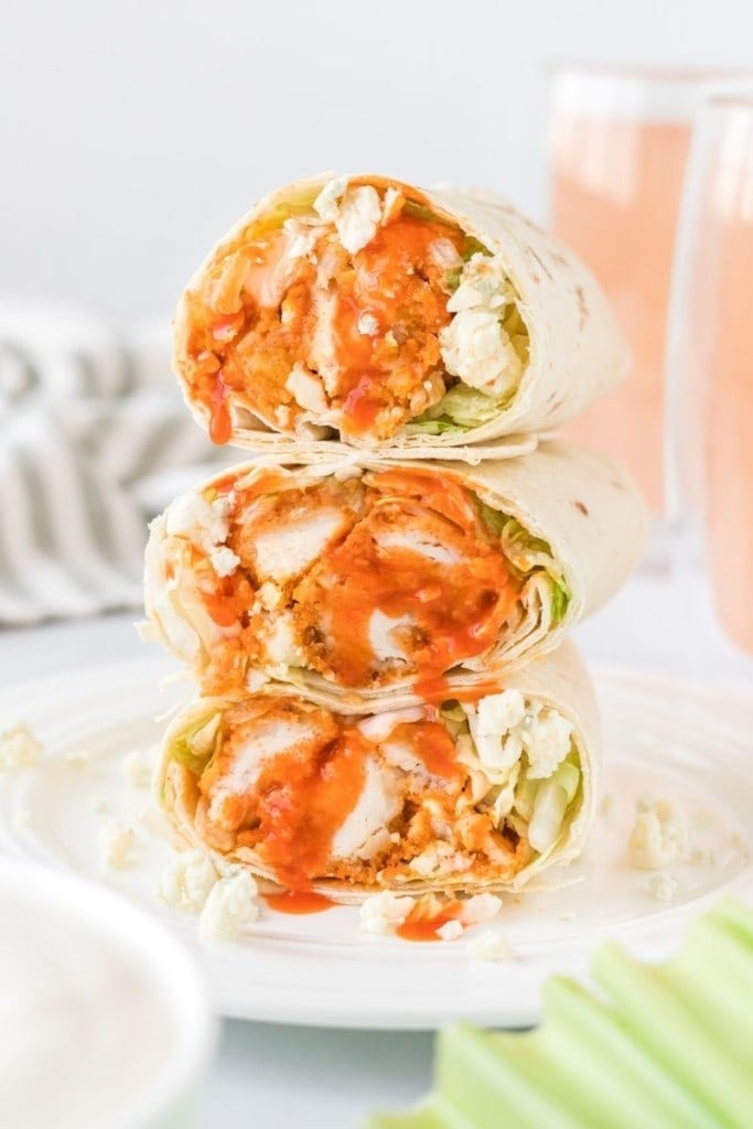 Buffalo Chicken Wrap cut in half side by side on a white plate