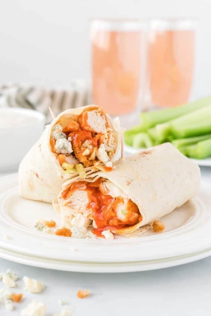 Closeup of Buffalo Chicken Wrap cut in half on a white plate