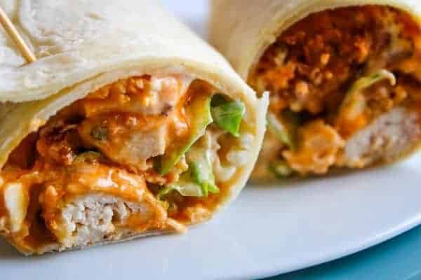 Closeup of Buffalo Chicken Wrap cut in half on a white plate