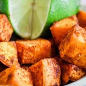 Close Up Sweet Potatoes with Lime with full lime with a slice out of it
