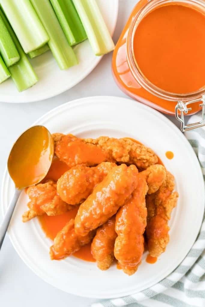 Chicken tenders coated in delicious buffalo sauce on a plate 