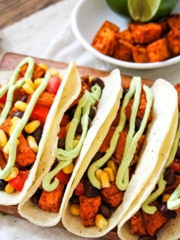 Sweet Potato Black Bean Tacos with white bowl of Mexican potatoes in background