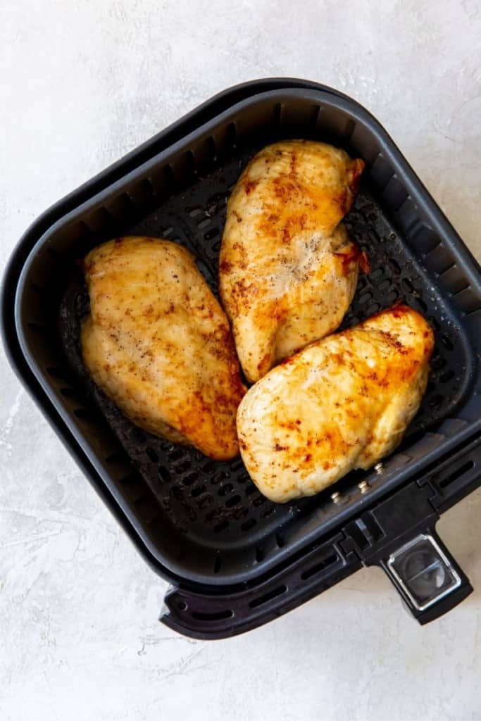 Title and Shown: The Best Air Fryer Chicken Breasts (on a white plate)