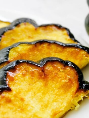 Closeup of acorn squash slices on a white plate