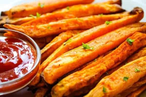 Closeup of Air Fryer Sweet Potato Fries with ketchup on the side