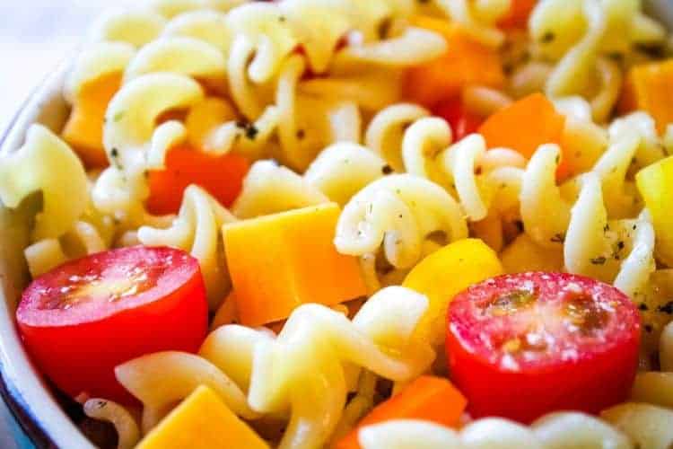 Closeup of Italian Pasta Salad with tomatoes, peppers, and cheese shown