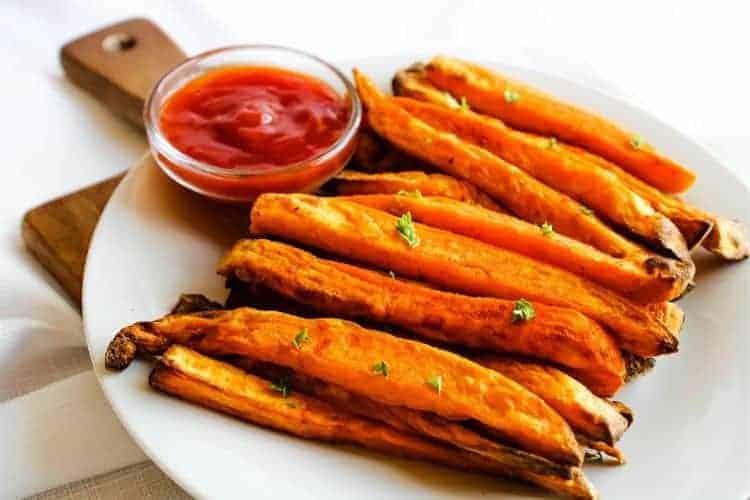 Sweet Potato Fries with Ketchup on a white plate