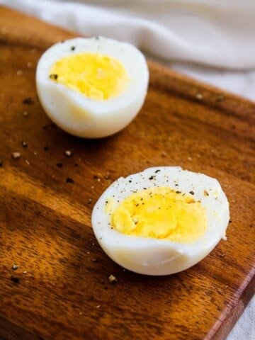 Air Fryer Hard Boil Eggs on cutting board halved