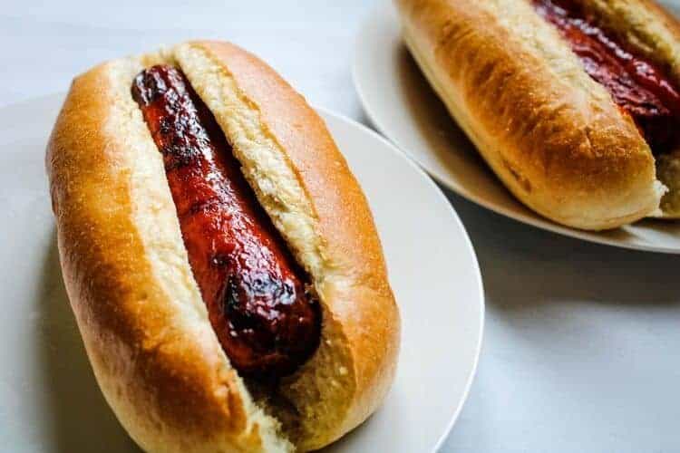 Two Air Fryer Hot Dogs on a white plate