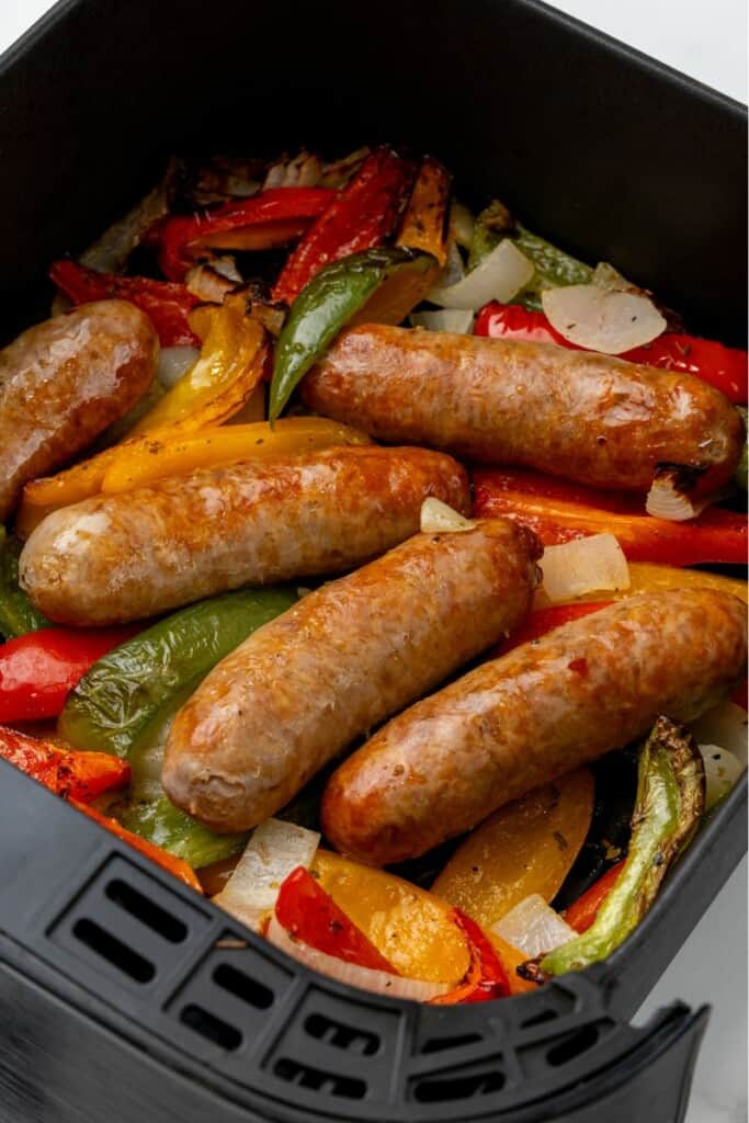 Cooked italian sausage in the air fryer with peppers and onions