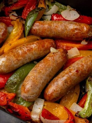 Italian sausage with peppers and onions cooked in an air fryer basket