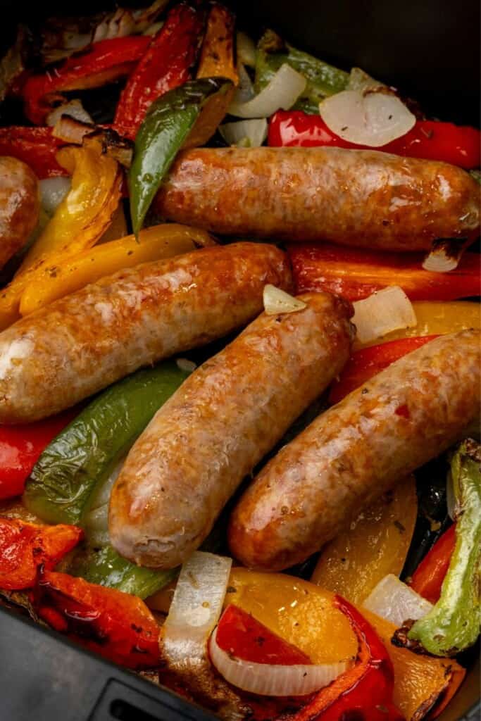 Italian sausage with peppers and onions cooked in an air fryer basket