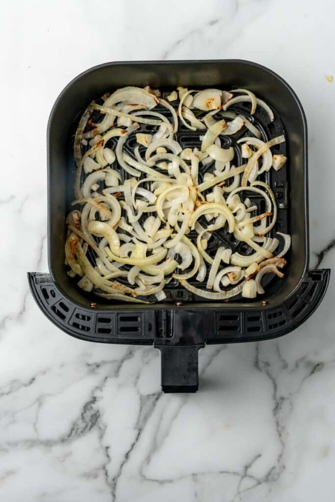 Cooked onions in air fryer basket