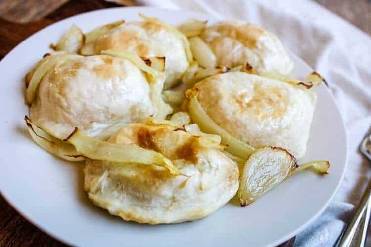 Air Fryer Frozen Pierogies with Onions on a white plate