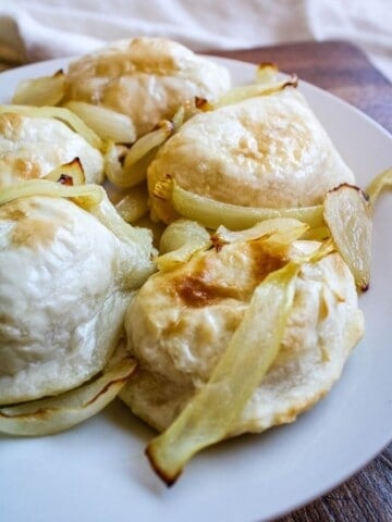 Air Fryer Pierogies with onions on a white plate