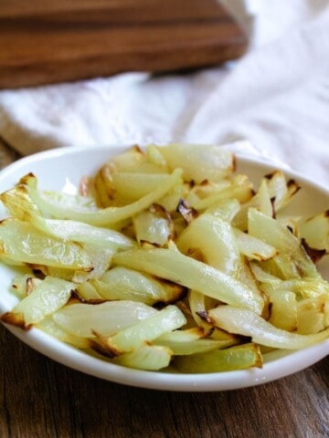 Air Fryer Sauteed Onions in a white shallow bowl