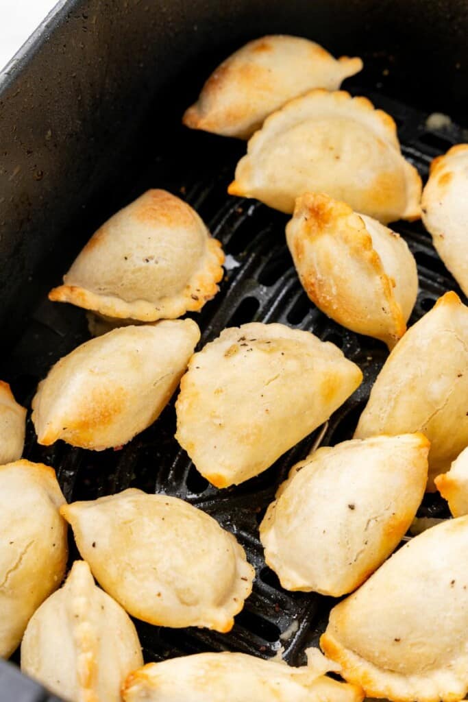 close up of cooked pierogies in an air fryer
