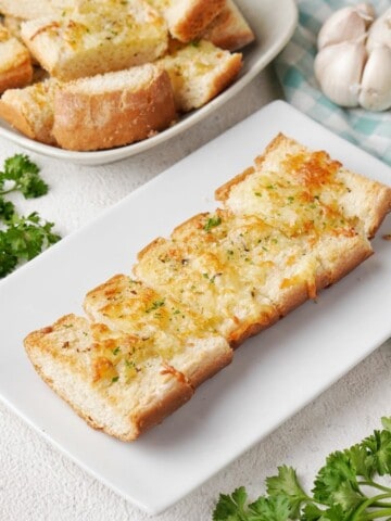 Sliced garlic cheese bread on a plate