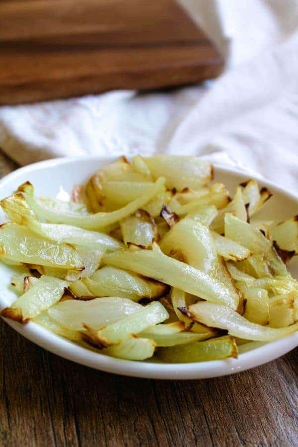 Air Fryer Sauteed Onions in white shallow bowl