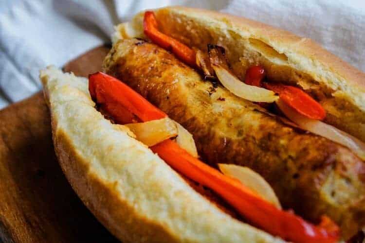 Closeup of Air Fryer Italian Sausage Sandwich on cutting board