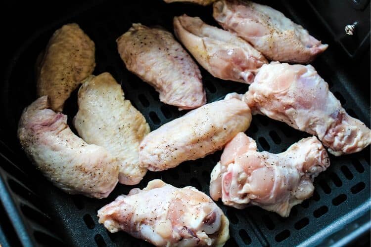 Raw chicken wings inside air fryer
