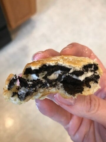 Air Fried Oreo held in hand with bite out of it