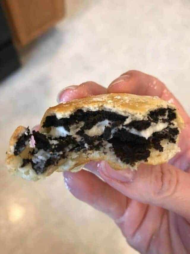 Air Fried Oreo held in hand with bite out of it