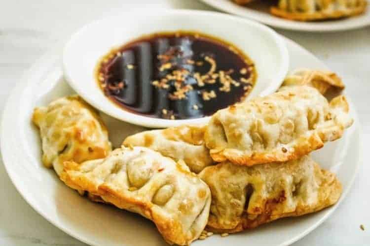 Air Fryer Dumplings with Sauce on a white plate