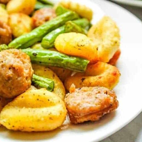 Air Fryer Gnocchi, Sausage, and Green Beans on a white plate