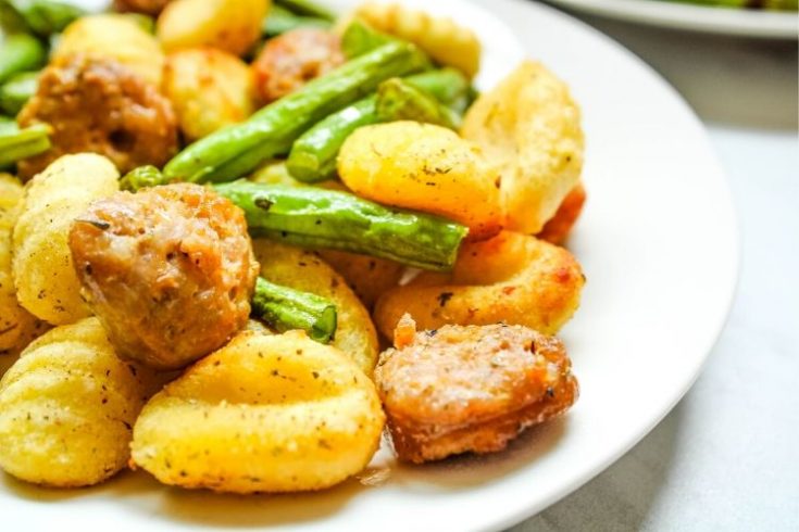 Air Fryer Gnocchi, Sausage, and Green Beans on a white plate
