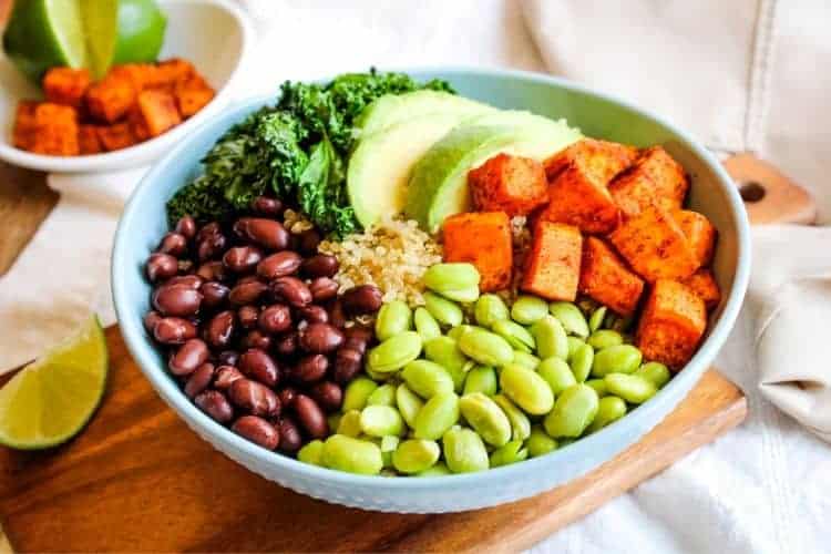 Sweet Potato Buddha Bowl in blue bowl with ingredients sectioned in circle