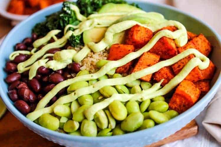 Grain Bowl with Avocado Sauce on top in a blue bowl