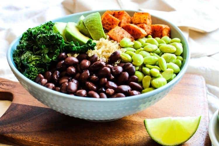 Buddha Bowl in a blue bowl with a lime wedge on the side