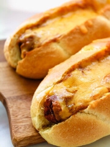 Chili Cheese Air Fryer Dogs on a cutting board