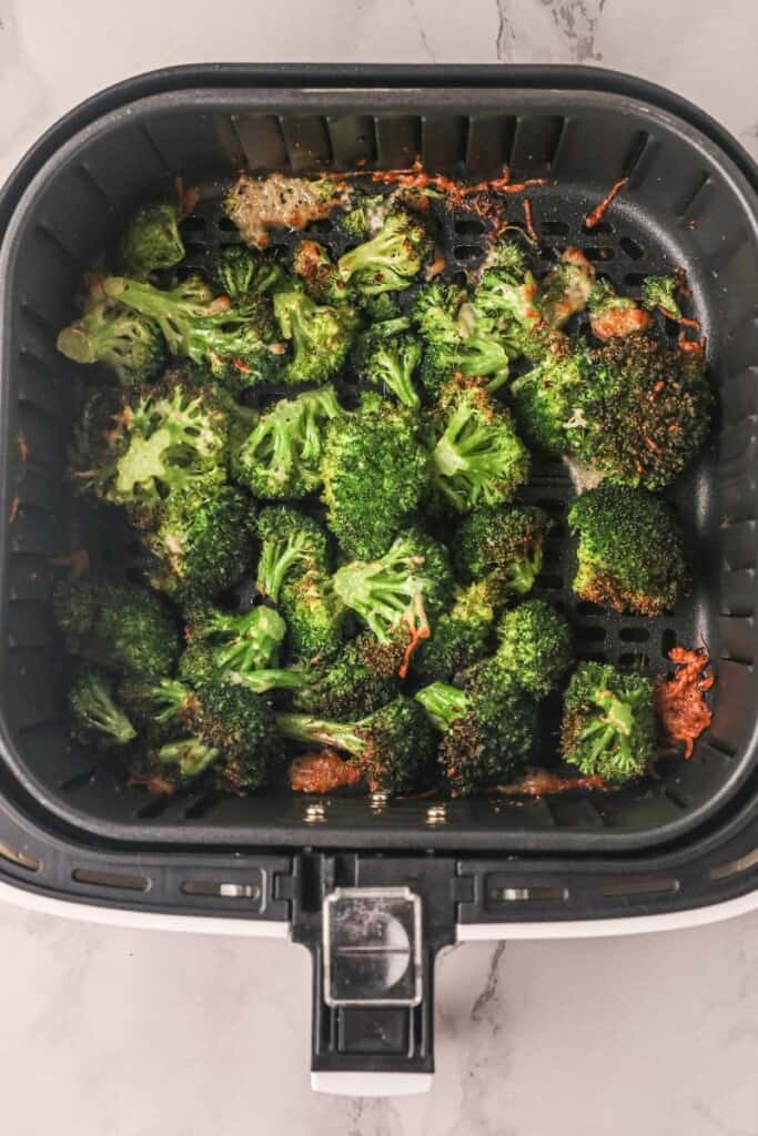 Cooked broccoli in air fryer with parmesan cheese