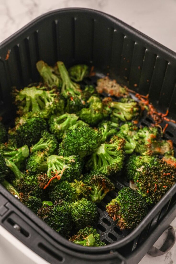 Roasted broccoli in air fryer basket cooked