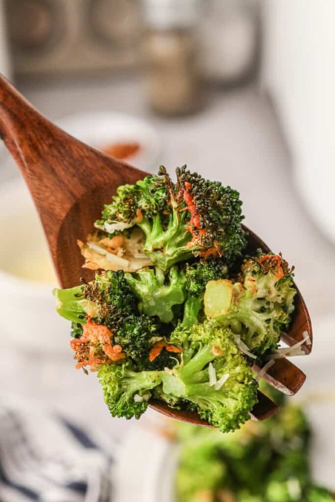 Close up of air fryer broccoli on a wooden spoon