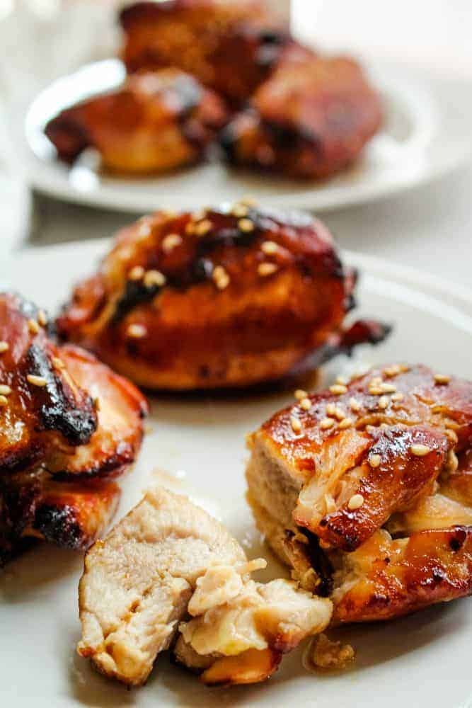 Chicken Thighs Cut on a white plate with sesame seeds on top