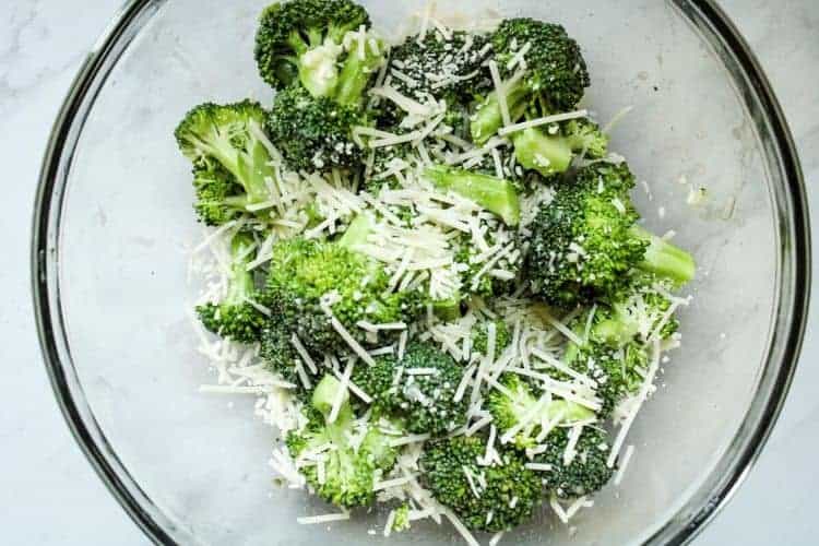 Broccoli with Shredded Parmesan in a clear bowl