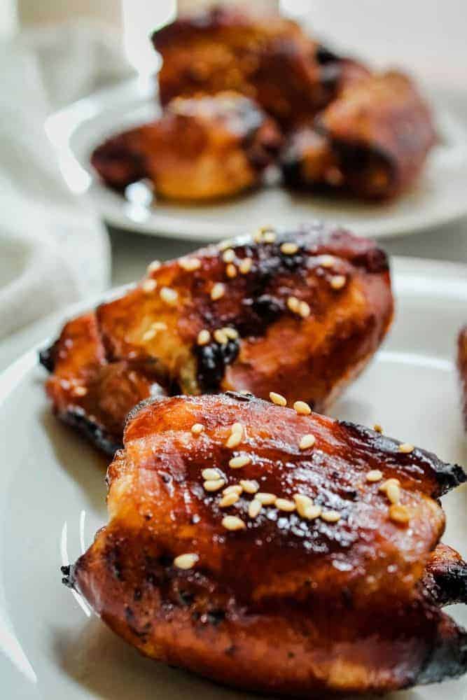 Honey Soy Chicken Thighs with sesame seeds on a white plate