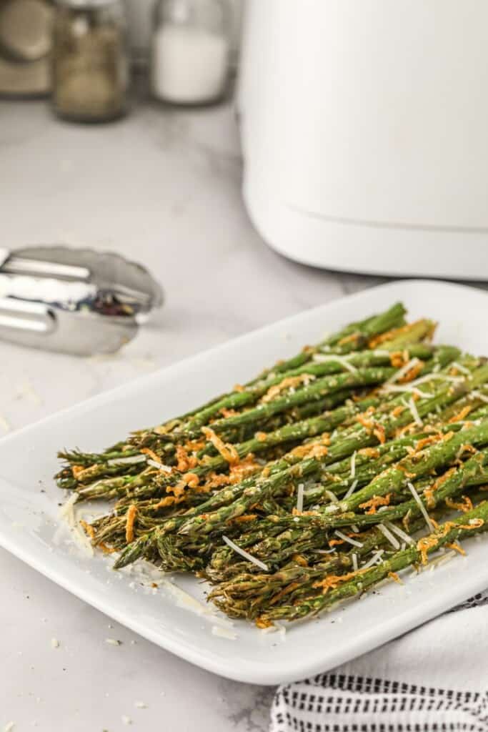 Air fried asparagus on a white plate