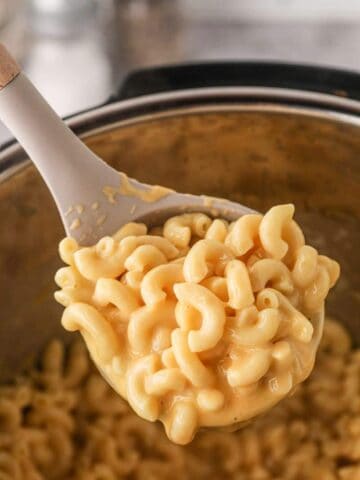 Wooden spoon full of creamy Instant Pot Mac and Cheese