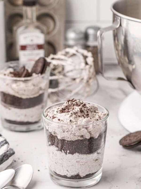2 cups of oreo mousse in front of a stand mixer bowl