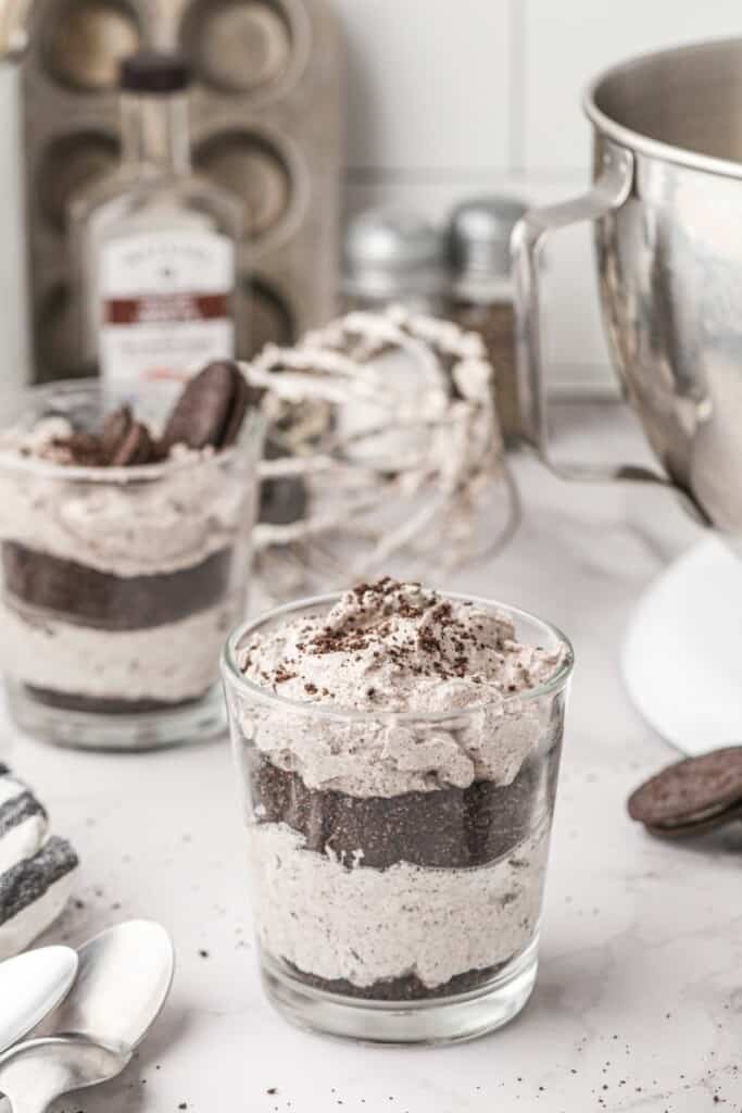 2 cups of oreo mousse in front of a stand mixer bowl