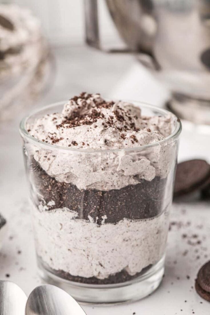 Glass filled with oreo mousse with oreo crumbs on top