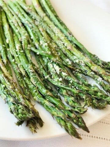 Air fryer Asparagus with parmesan on a white plate